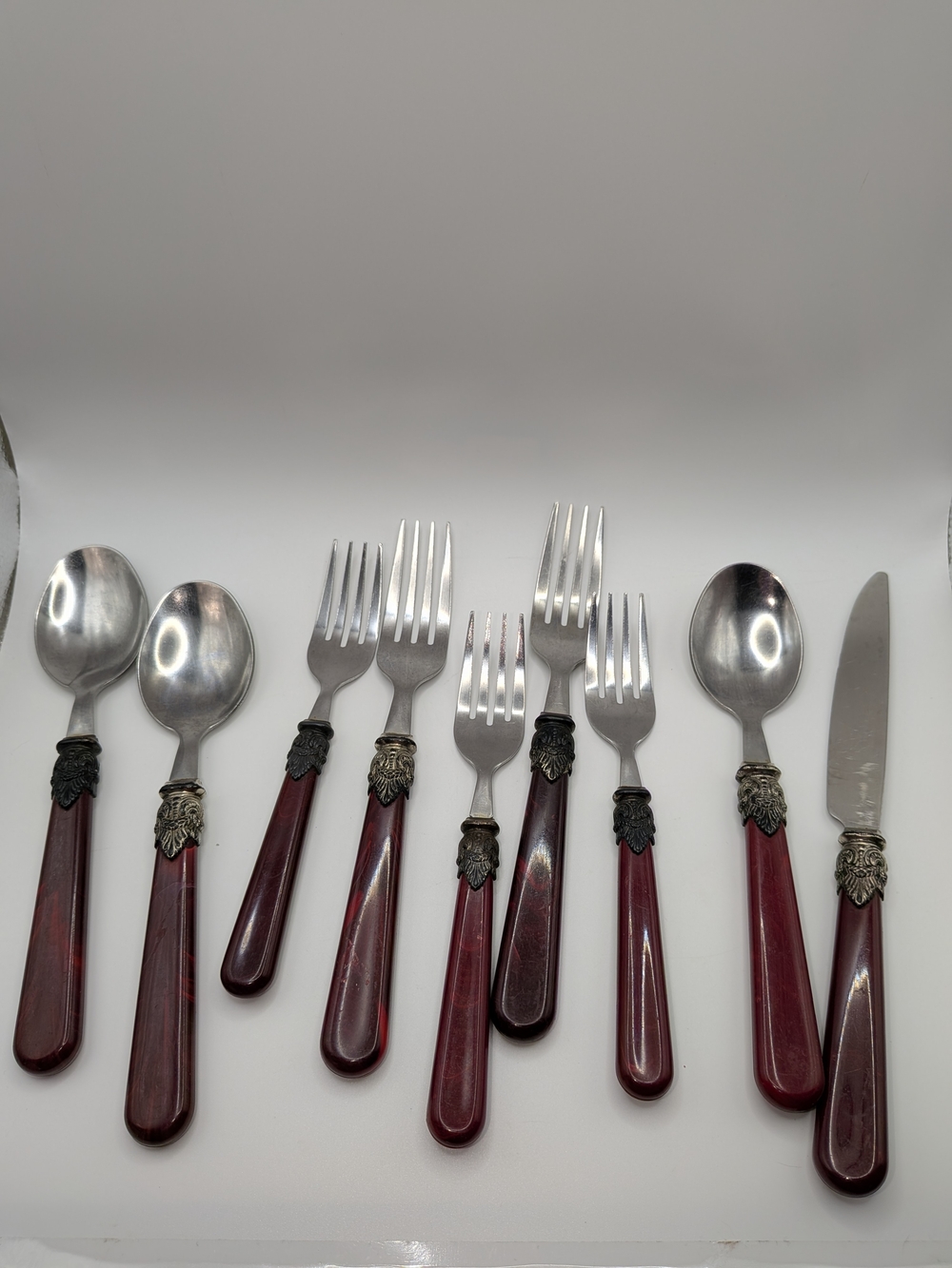 Vintage Burgundy Handle Flatware Set with Ornate Silver Accents